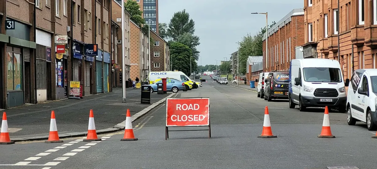 Road closed sign and police vehicles on George Street in Paisley